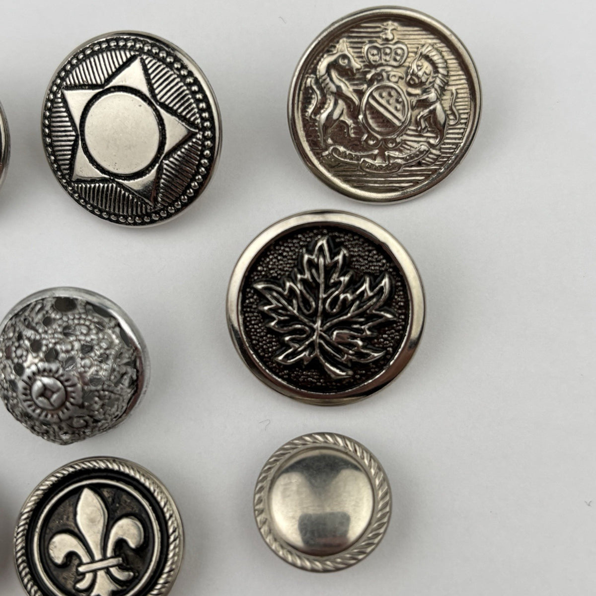 Vintage Silver Crest Button Lot – Fleur-de-Lis, Maple Leaf, Crown & Star, 15pcs