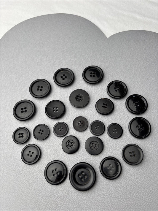 Vintage black button lot — 23 Assorted 4-hole sew-through styles.