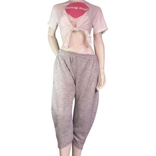 Mannequin wearing a pink crop top and gray capri pants on a white background