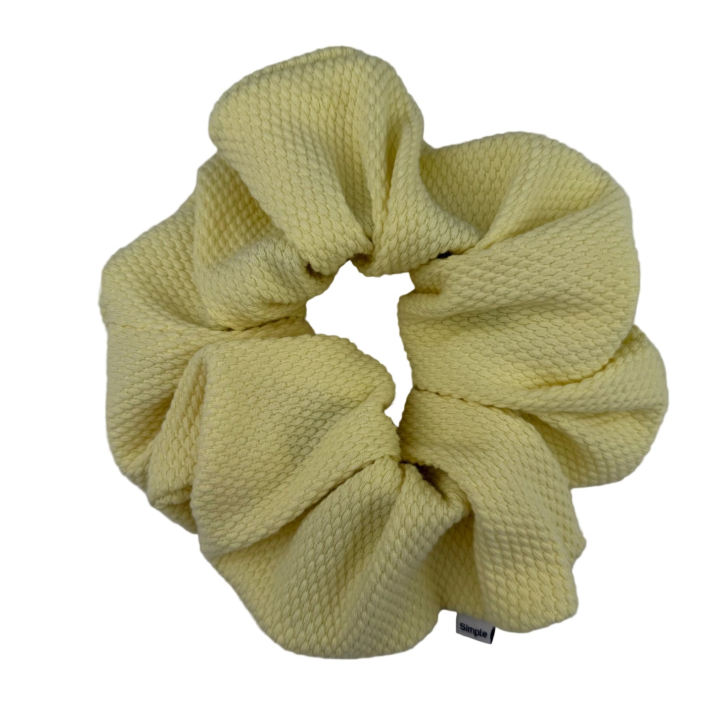 Yellow scrunchie on a light gray background