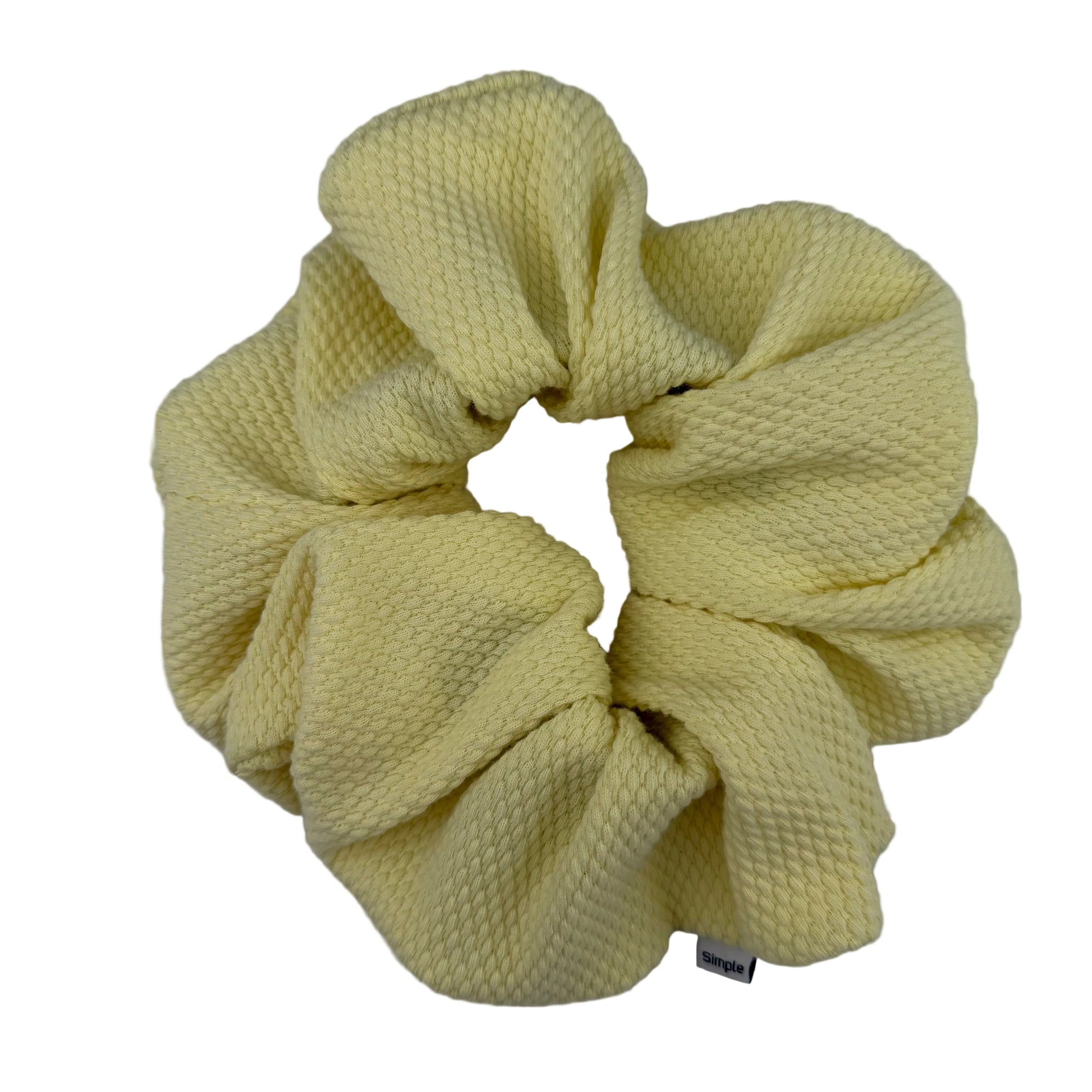 Yellow scrunchie on a light gray background